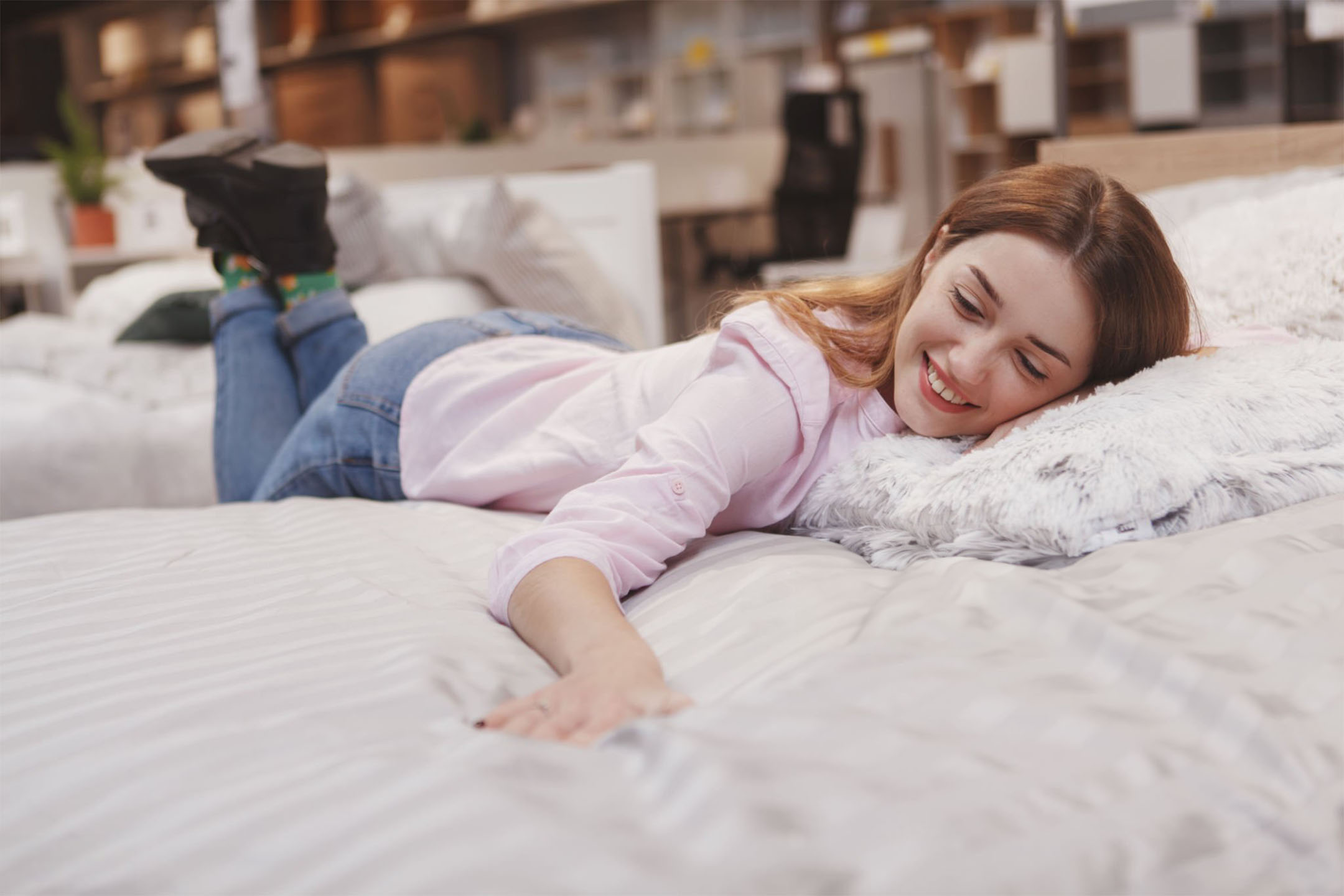 woman checking comfort of mattress